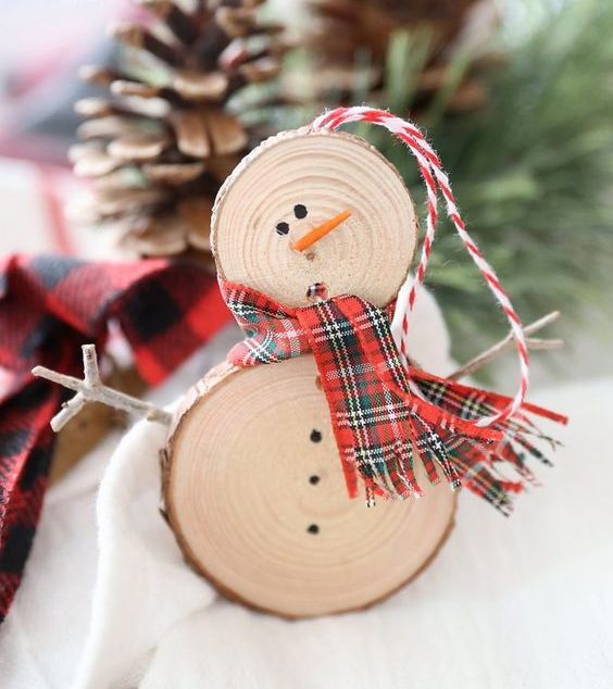 a rustic snowman ornament of wood slices, a plaid scarf and some sticks is ideal for Christmas