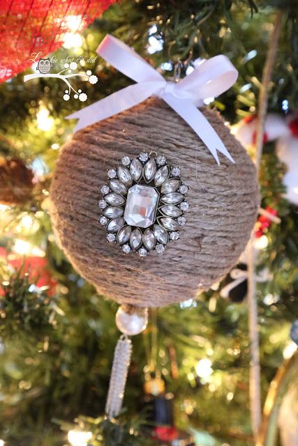 a rustic vintage Christmas ornament of twine, an embellishments, a white bow and a pearl is very beautiful