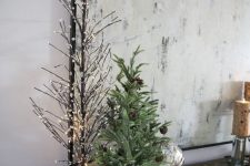 a small Christmas tree with pinecones placed in a basket is a cool woodland and rustic decor idea