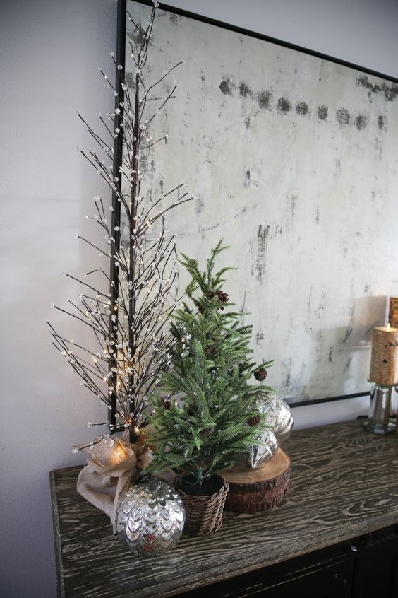 a small Christmas tree with pinecones placed in a basket is a cool woodland and rustic decor idea