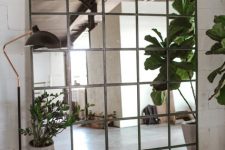 a statement industrial mirror made of IKEA LOTS mirrors is a bold idea for any space and it will fit many decor styles you might have