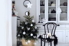 a stylish small Christmas tree with white and sheer ornaments put into a basket is a lovely and beautiful idea