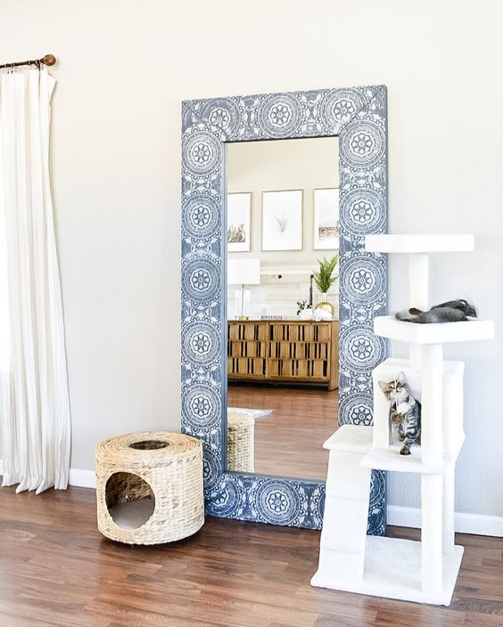 a usual IKEA mirror given a new frame that features blue and white stenciling for a chic and bold look