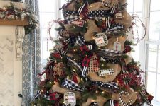 a vintage rustic Christmas tree decorated with polka dot and plaid ribbons, burlap ribbons, lights, stars and snowflakes plusa bold topper