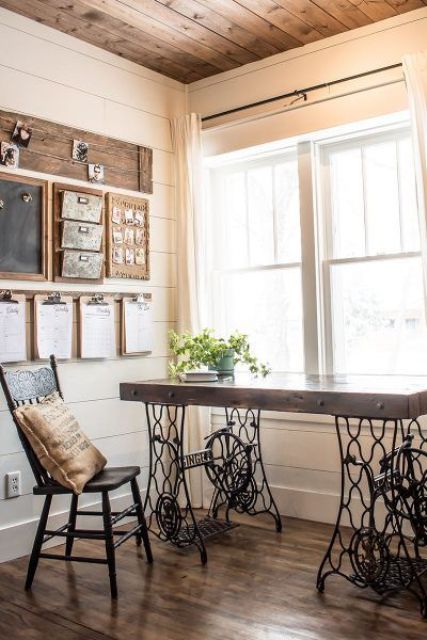 a vintage rustic home office with a vintage desk, a wooden chair, a gallery wall with note boards and neutral linens