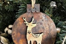a wooden Christmas ornament with rust decor and a little wooden deer on it is a lovely and pretty piece
