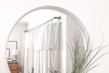 an IKEA Ypperlig mirror turned into a stylish wall piece with an air plant space is a very modern and bold solution