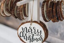 lovely wood slice Christmas ornaments in black and white, with quotes are ideal for a cozy rustic feel