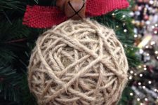 twine wrapped Christmas ornament with red burlap and rust bells is a great rustic decoration that you can make