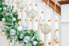 02 a fir garland with beads, silver and blue ornaments and twigs and gold ornaments for Christmas stairs decor