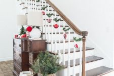 03 lovely Christmas railing decor with red and silver ornaments and fir twigs is a bold and easy idea to try