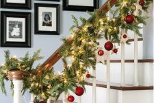 07 cute Christmas railing decor with fir branches, lights, red ornaments and clay stars is easy and very holiday-like