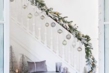 08 flocked fir branches with lights, pastel and silver ornaments hanging on the railing and silver and lavender decor