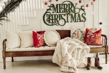 09 cozy Christmas stairs decor with gold and red ornaments hanging and green letters attached plus a lush fir branch garland