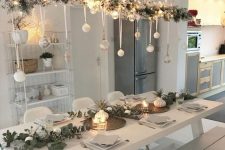 10 a beautiful overhead Christmas installation of flocked branches, lights, sheer and white ornaments is a pretty Nordic decor idea