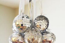 12 a chandelier spruced up with silver, silver sequin and silver glitter ornaments for Christmas is chic