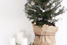 12 a small Nordic Christmas tree with wooden bead ornaments and a kraft paper cover is a pretty and nice idea with a natural feel