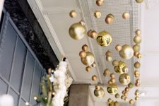15 a gold, copper and green overhead Christmas ornament installation can be rocked in your front porch, too
