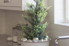 16 a bowl with silver ornaments and a small Christmas tree with pinecones is a lovely idea for simple and minimal holiday decor