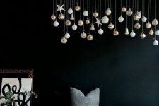19 an overhead Christmas installation of a branch with white and gold ornaments is a great idea for every kind of space