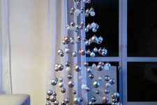 28 a levitating Christmas tree of white and silver ornaments is a lovely and out of the box idea for winter