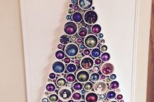 29 a PVC pipe Christmas tree with colorful ornaments inserted for decor is a cool alternative to a usual Christmas tree