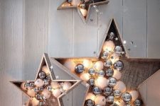 37 plywood stars filled with white and silver ornaments, stars and lights are gorgeous holiday decorations to rock