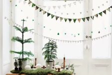 Christmas banners and garlands made of little ornaments are great to style a window for the holidays