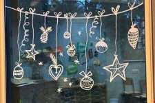 Christmas paint window decor with ornaments just painted on it is a cool and catchy decor idea