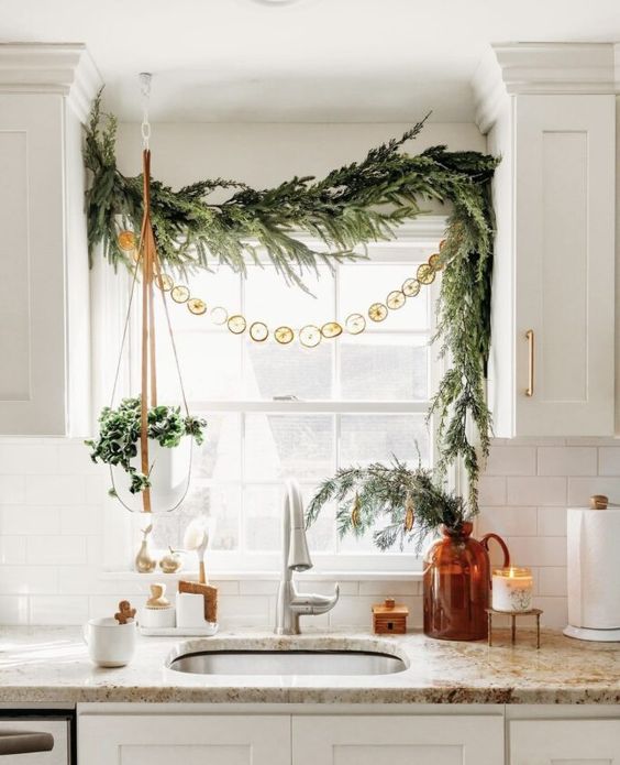 Christmas window decor with evergreens, dried citrus, greenery is a cool and catchy solution for the holidays