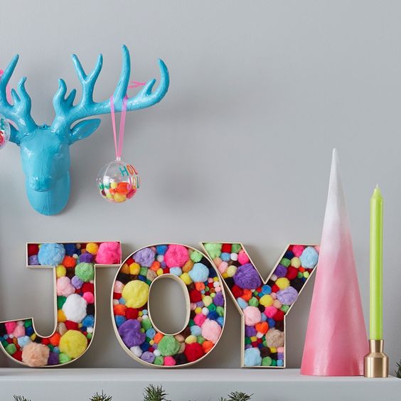 JOY letters filled with colorful pompoms are great for fun modern Christmas decor and you can make them yourself