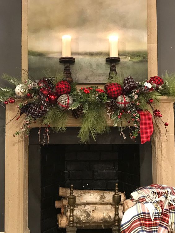 a Christmas mantel with faux fir and other branches, plaid and silver ornaments, plaid ribbons and candles is a very cozy idea