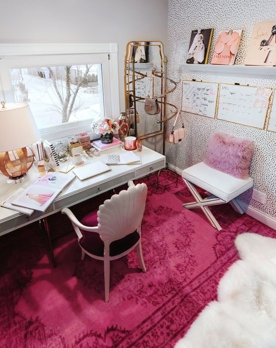 a bold glam home office with a lavender pillow, a hot pink rug, some pink accessories and touches