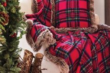 a bold red plaid blanket and pillow with brown faux fur will make your space cozier and more Christmassy, with a traditional feel