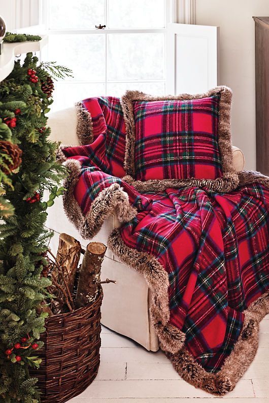 a bold red plaid blanket and pillow with brown faux fur will make your space cozier and more Christmassy, with a traditional feel
