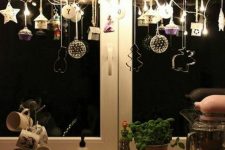 a branch with whimsical ornaments, lights and cookie cutters will make your kitchen look very cool