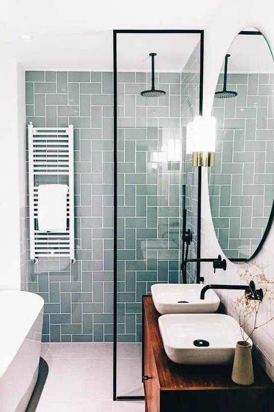a bright contemporary bathroom with aqua green tiles in the shower space, a floating vanity and a tub