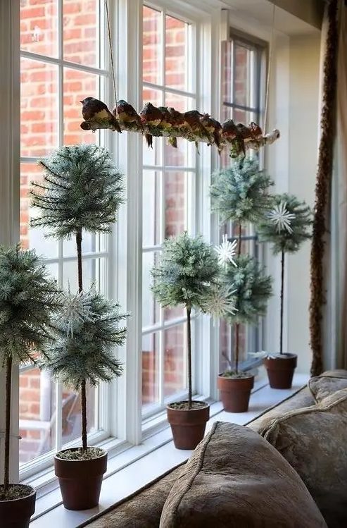 a bunch of faux tabletop evergreens in different sizes would make a perfect windowsill's display