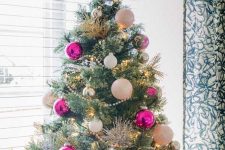 a chic and glam Christmas tree with lights, pink, white and silver ornaments and a vine star on top looks just amazing and very shiny