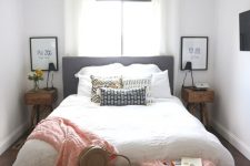 a cozy small bedroom with stained nightstands, a bed with neutral bedding, a bench, some pink blankets and pillows
