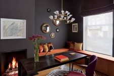 a fancy home office with a storage windowsill seating, a black desk, a fuchsia chair, a built-in fireplace and a lovely chandelier