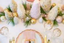 a glam Christmas tablescape with gold, pink and silver ornaments, mini tinsel trees, gold cutlery and fir touches is very chic