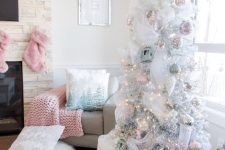 a glam pastel Christmas tree – a white one, with pastel ornaments, lights and white twigs plus pastel pillows