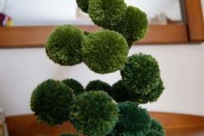 a green pompom swirl Christmas tree with a yellow star topper is a lovely and easy decoration for the holidays