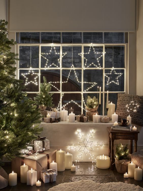 a pretty Christmas window with shiny light stars hanging is a cool and catchy decor idea for the holidays