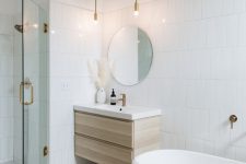a serene contemporary bathroom with white tiles and a terrazzo floor, a shower space, an oval tub and a stained vanity