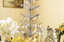 a silver tabletop Christmas tree with mother of pearl ornaments is a shiny and bright idea for holiday decor