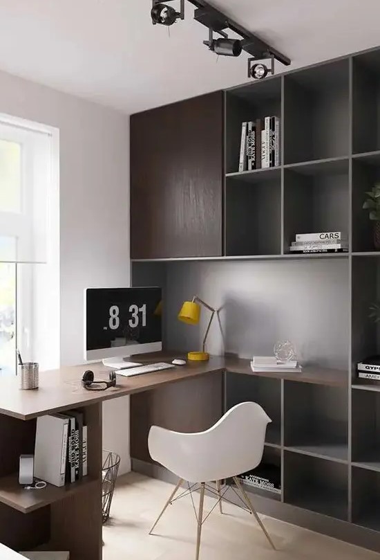 A simple contemporary home office with dark stained storage cabinets and a built in desk plus open storage units, a white chair