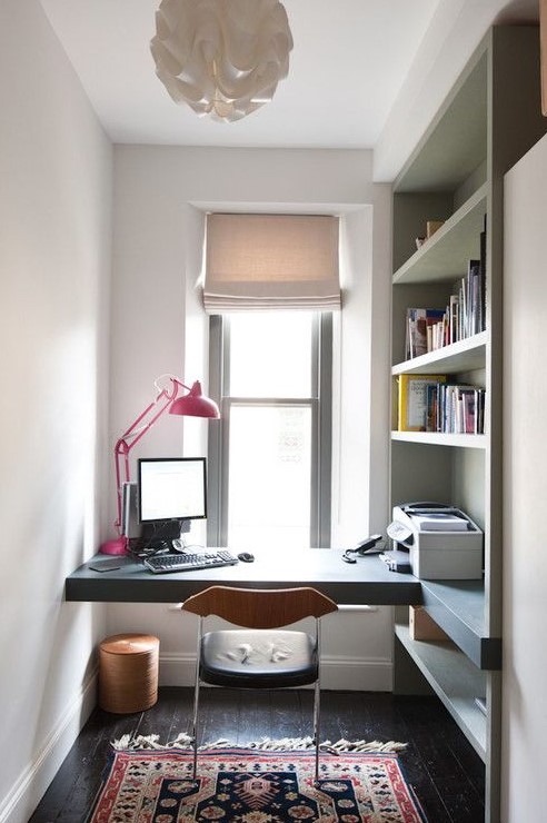 A small home office nook with built in open shelves that provide storage and fit the space perfectly