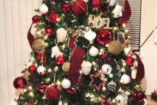 a super bright Christmas tree with plaid ribbons, white and red ornaments, bells, stars, twine baubles and letter decor